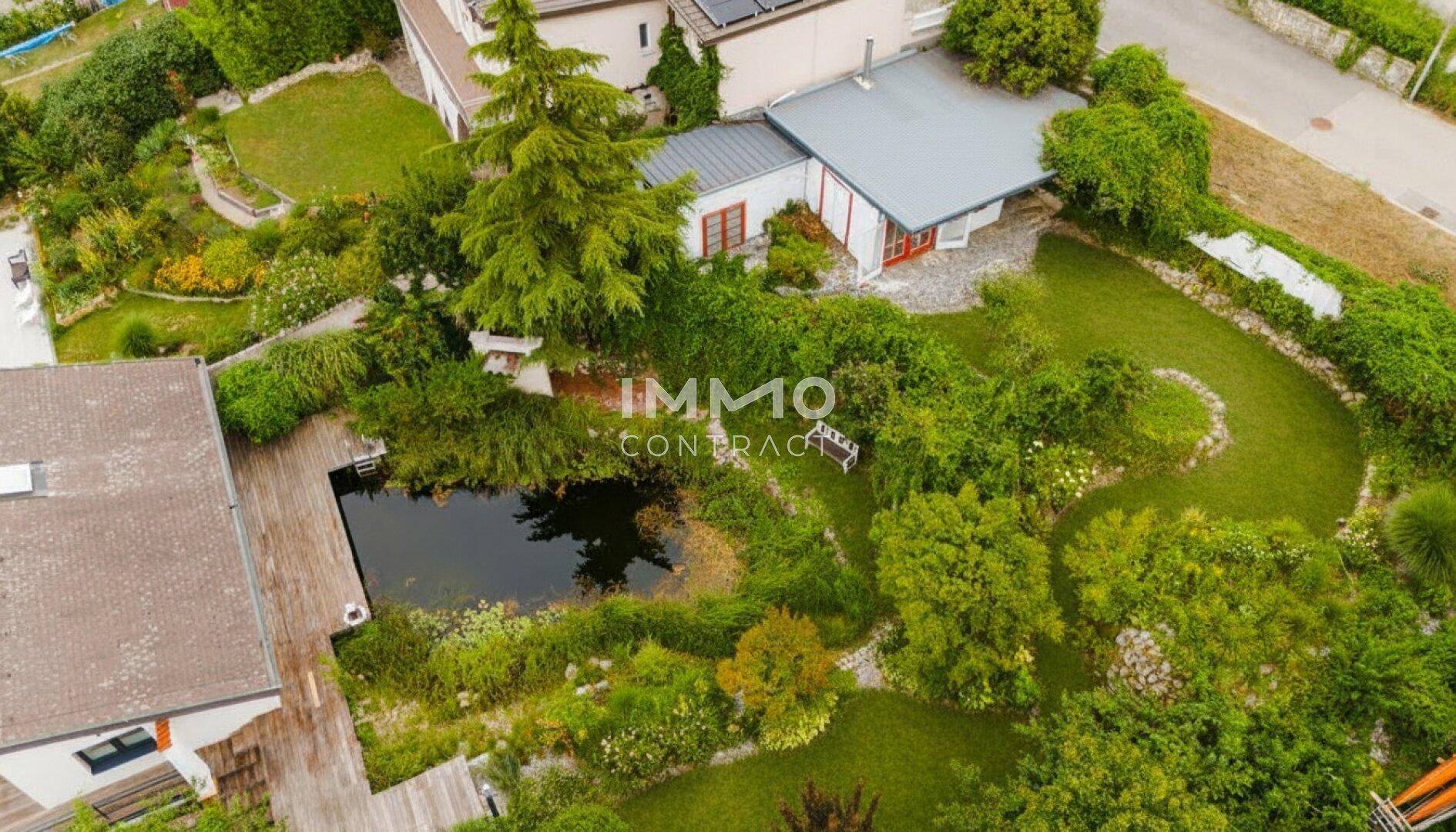 Überblick über das Anwesen mit großem Garten, Naturpool und angrenzenden Häusern.