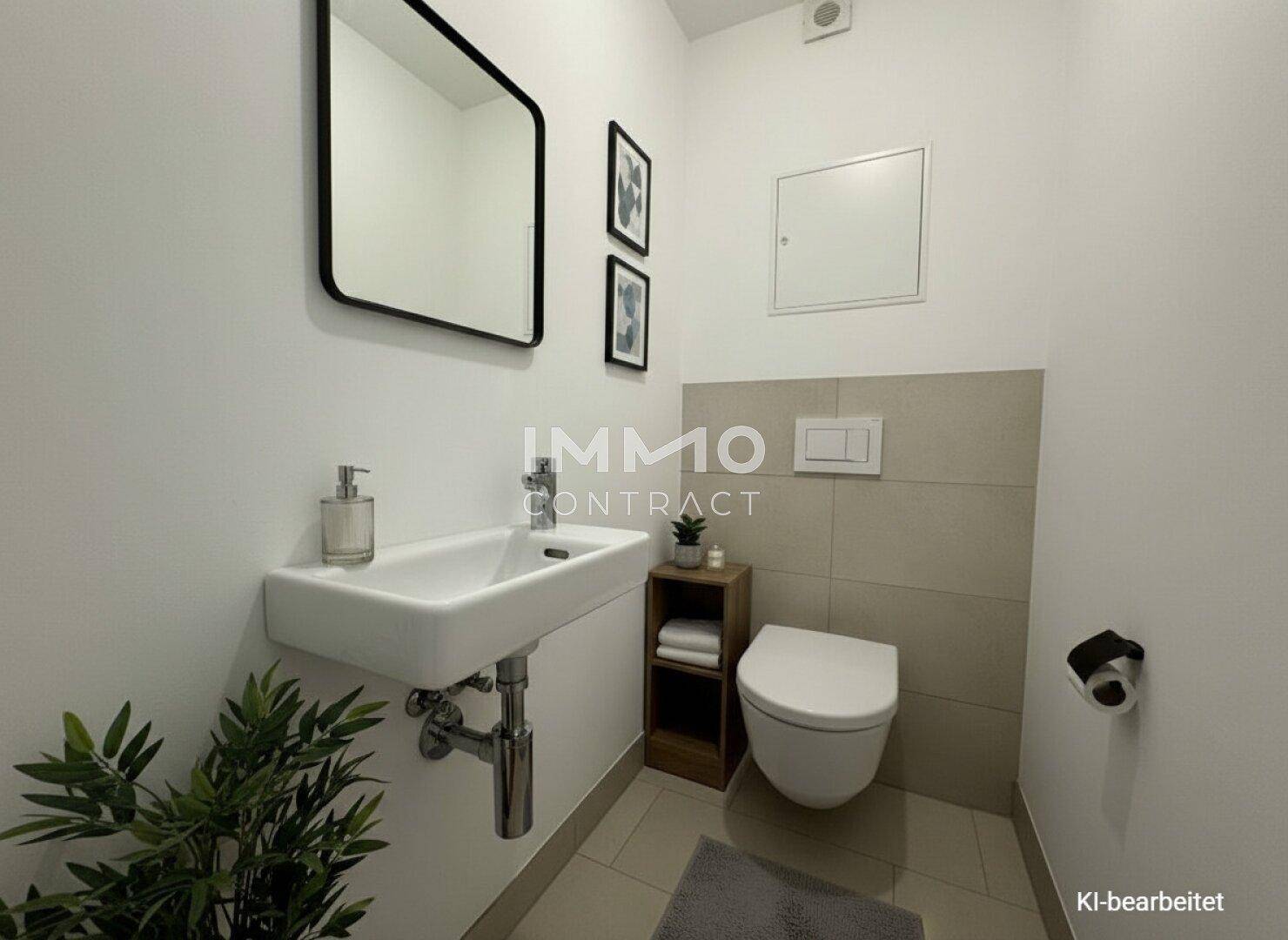 Kleines Gäste-WC mit modernem Waschbecken und Wand-WC.
