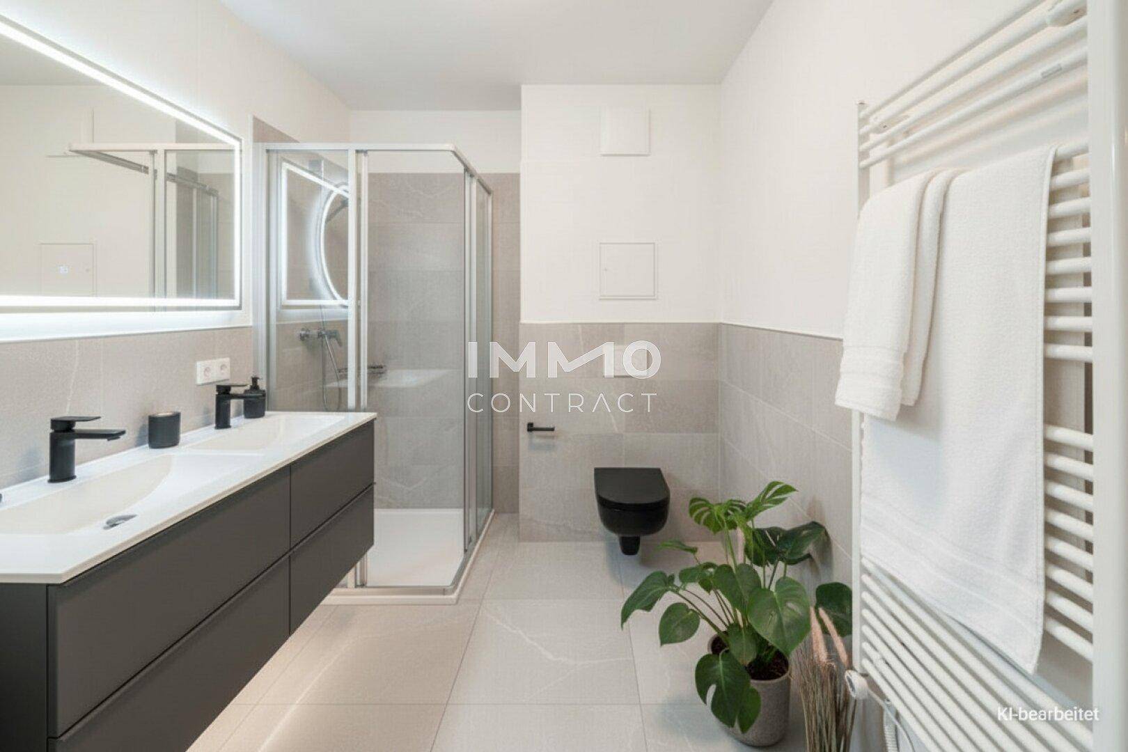 Modernes Badezimmer mit Doppelwaschbecken, begehbarer Dusche und beheiztem Handtuchhalter.