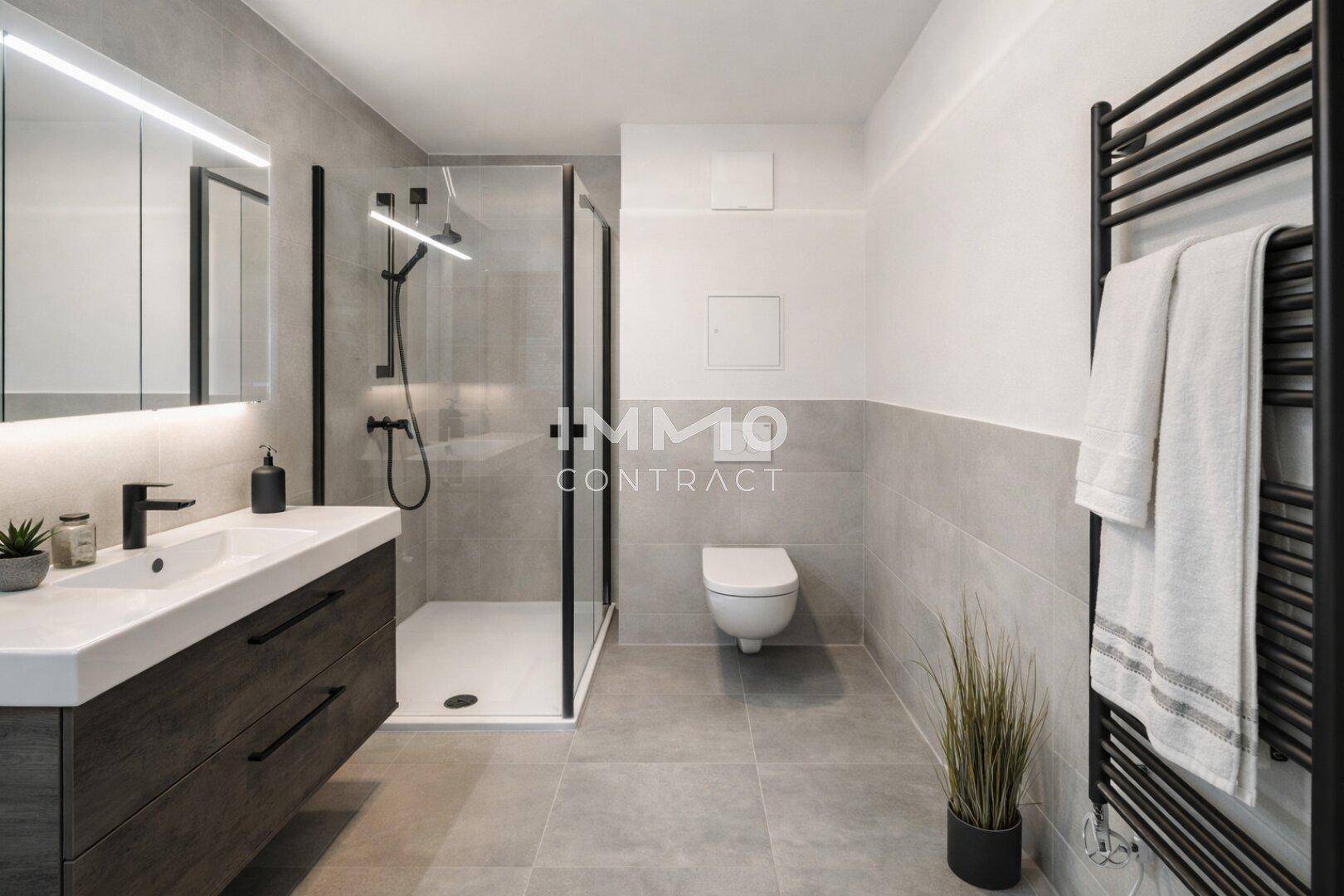 Modernes Badezimmer mit grauen Fliesen, begehbarer Dusche und elegantem Waschtisch.