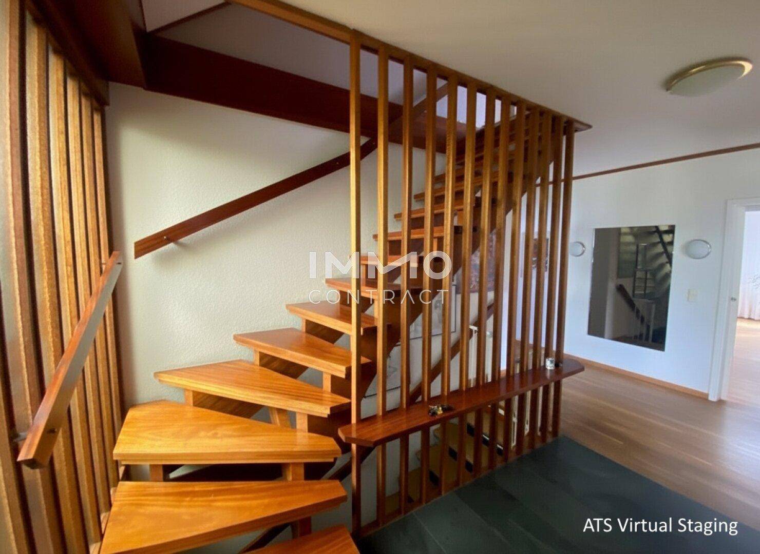Holztreppe mit modernem Geländer, die verschiedene Ebenen des Hauses verbindet.