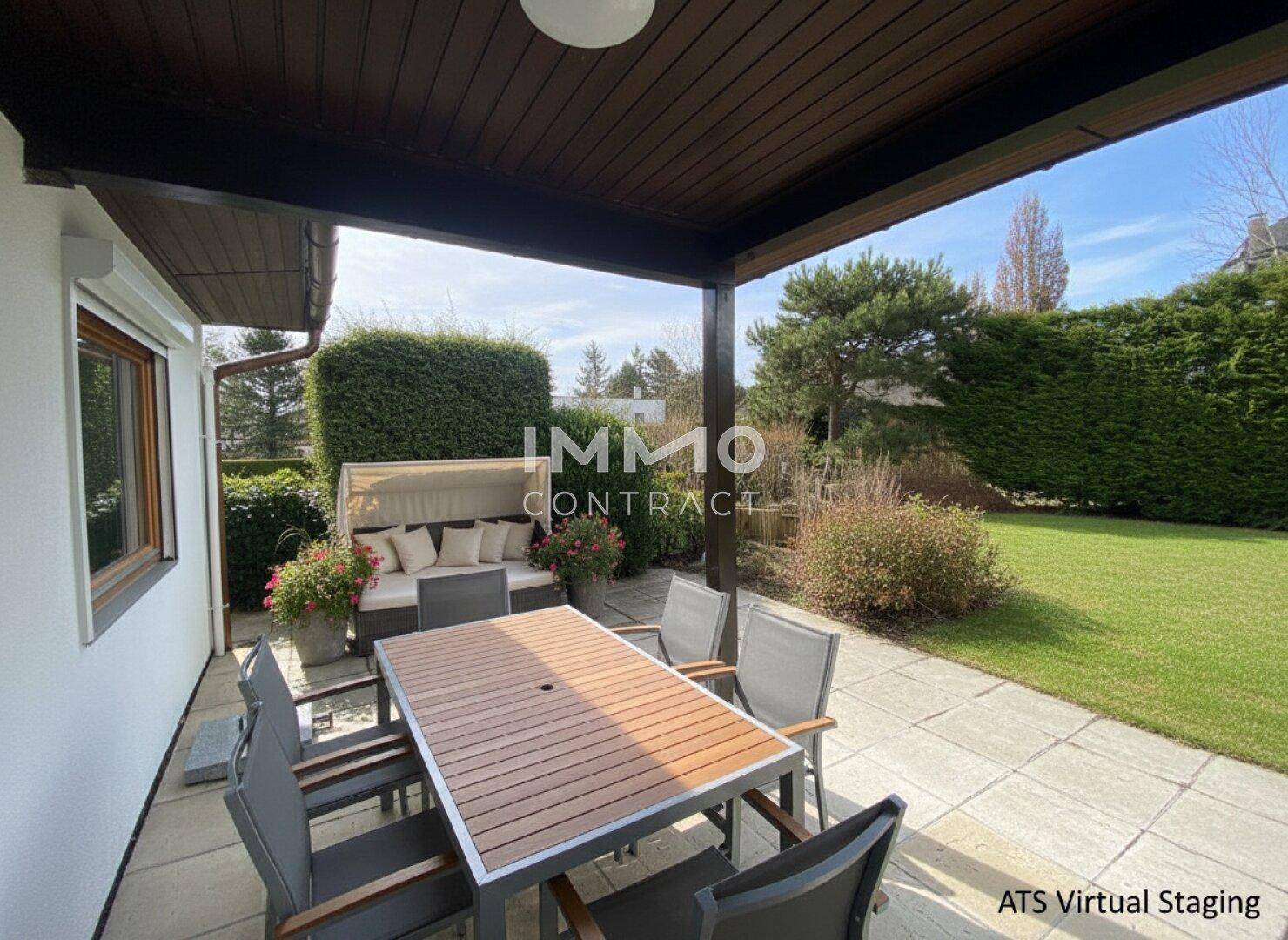 Überdachte Terrasse mit Esstisch und Stühlen, umgeben von einem gepflegten Garten.