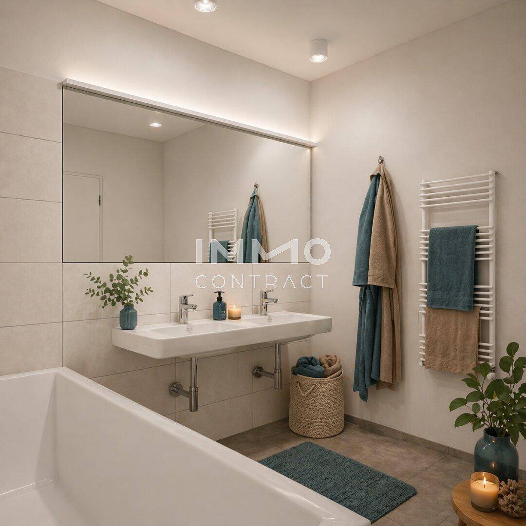 Modernes Badezimmer mit Doppelwaschbecken, Badewanne und beheiztem Handtuchhalter.