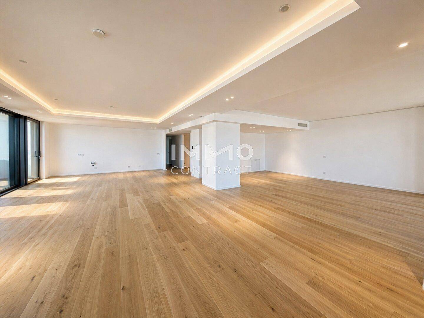 Offener, heller Wohnbereich mit Holzboden, hohen Decken und großen Fenstern.