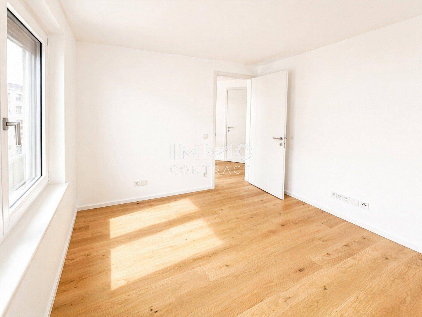 Helles Zimmer mit neuem Holzparkett und großen Fenstern, ideal als Schlaf- oder Arbeitszimmer.