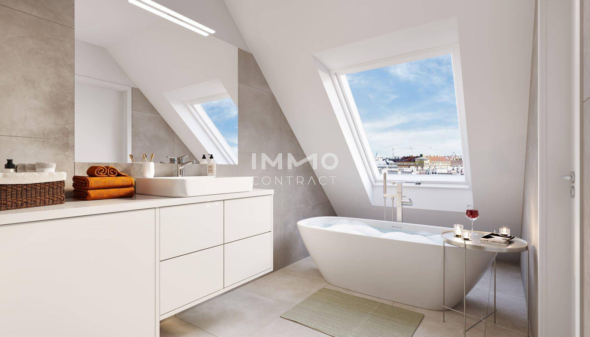 Modernes Badezimmer im Dachgeschoss mit freistehender Badewanne, Waschtisch und großem Dachfenster.