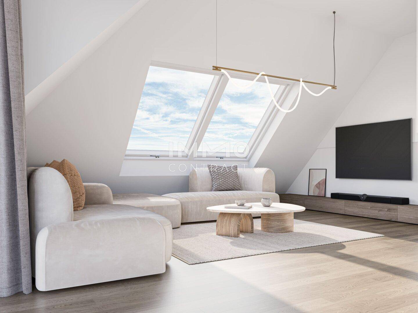 Helles Wohnzimmer im Dachgeschoss mit schrägen Wänden, großen Dachfenstern und stilvollen Möbeln.