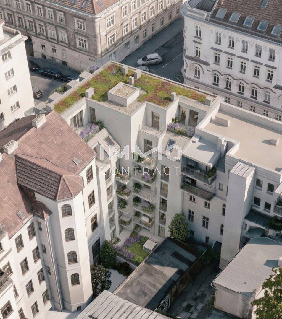 Luftaufnahme eines modernen Gebäudekomplexes mit begrünten Dächern und Balkonen in urbaner Umgebung.