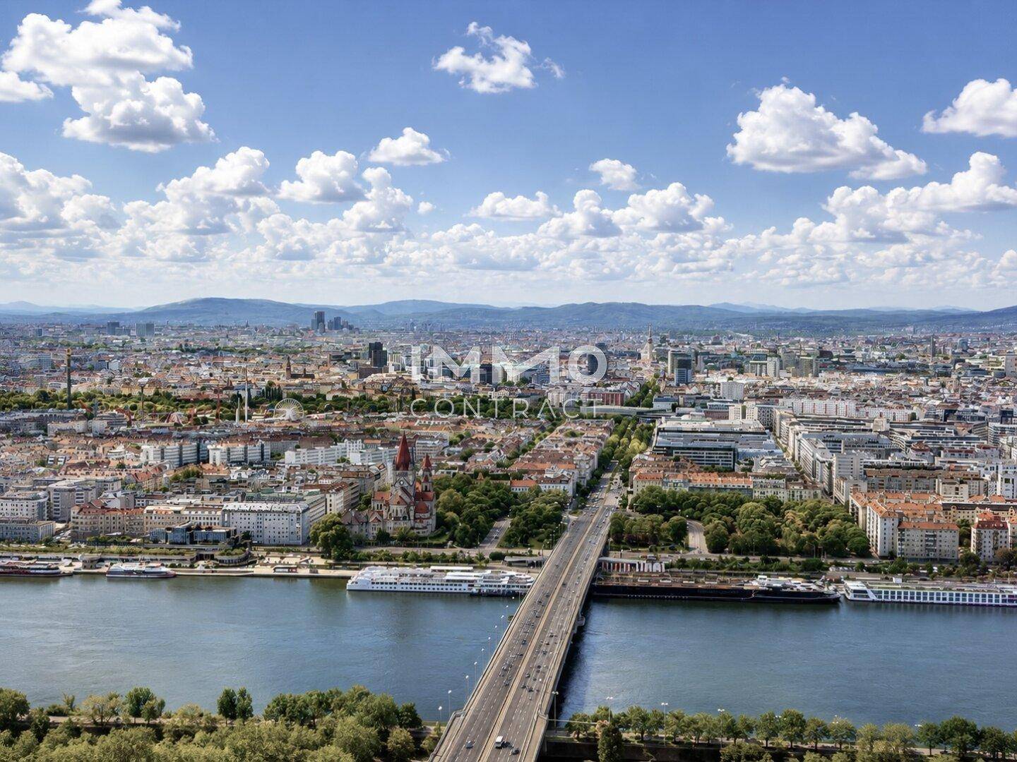 Beeindruckende Luftaufnahme einer Metropole mit Fluss, Brücken und weitläufiger Bebauung.