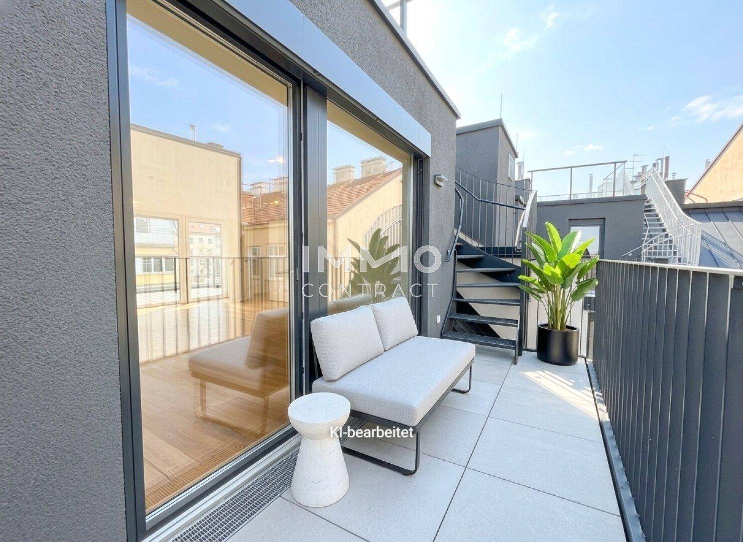 Kleiner Balkon mit Fliesenboden und Sitzgelegenheiten, verbunden mit einer Wendeltreppe zur Dachterrasse.
