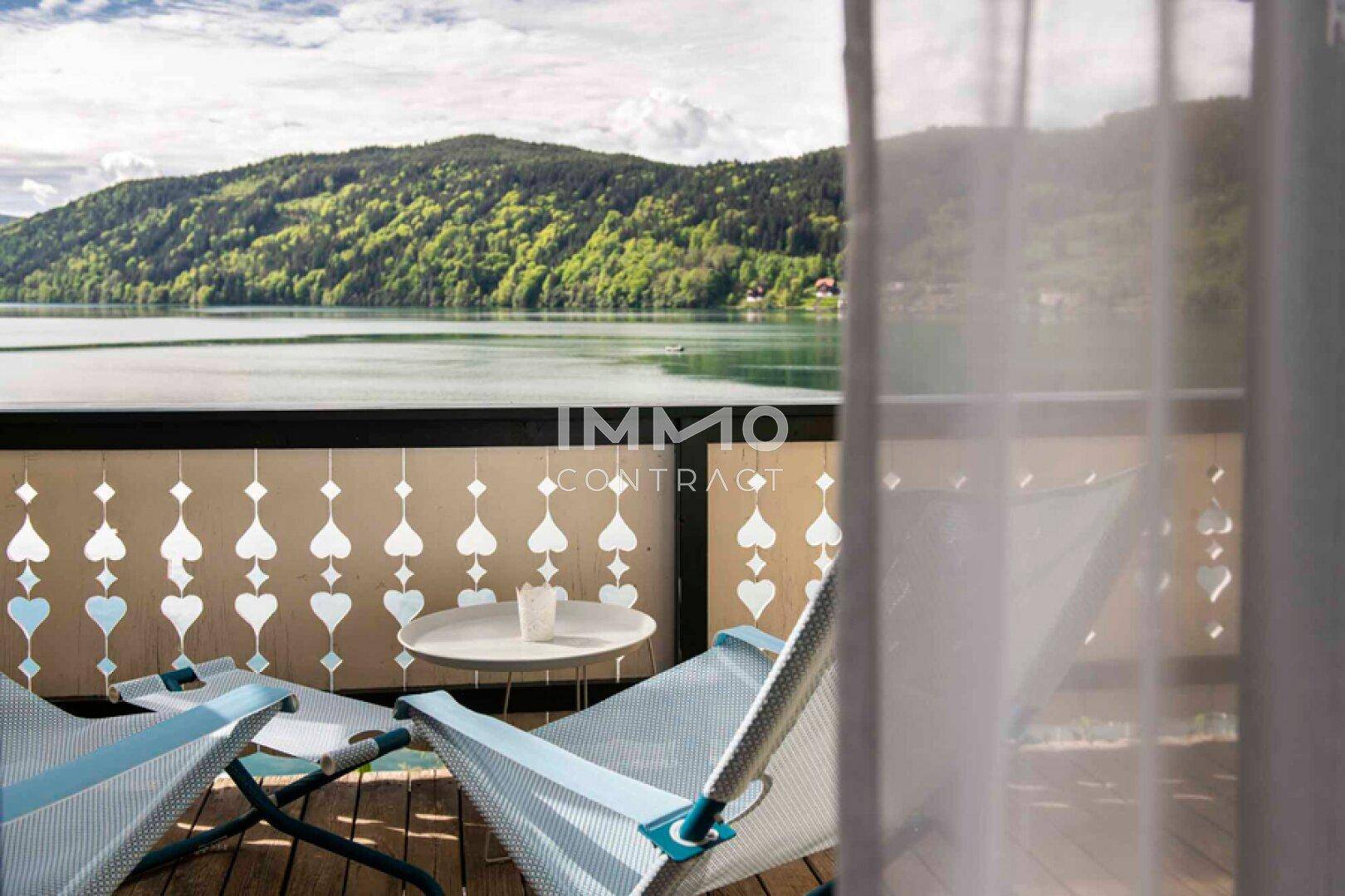 Gemütlicher Balkon mit Seeblick und bequemen Liegestühlen, ideal zum Entspannen im Freien.