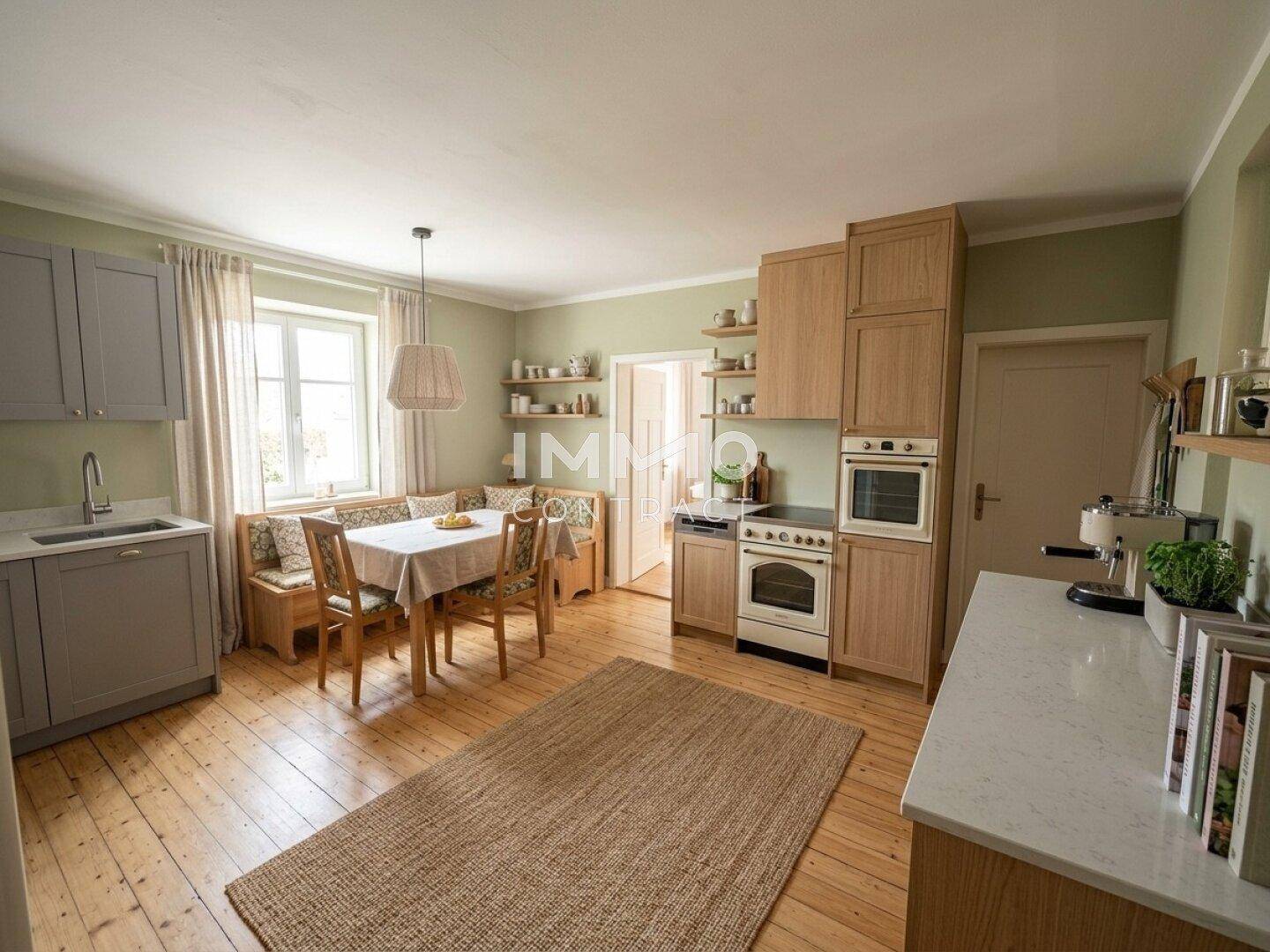 Helle, modernisierte Wohnküche mit Holzdielenboden, Essbereich und grünen Wänden.