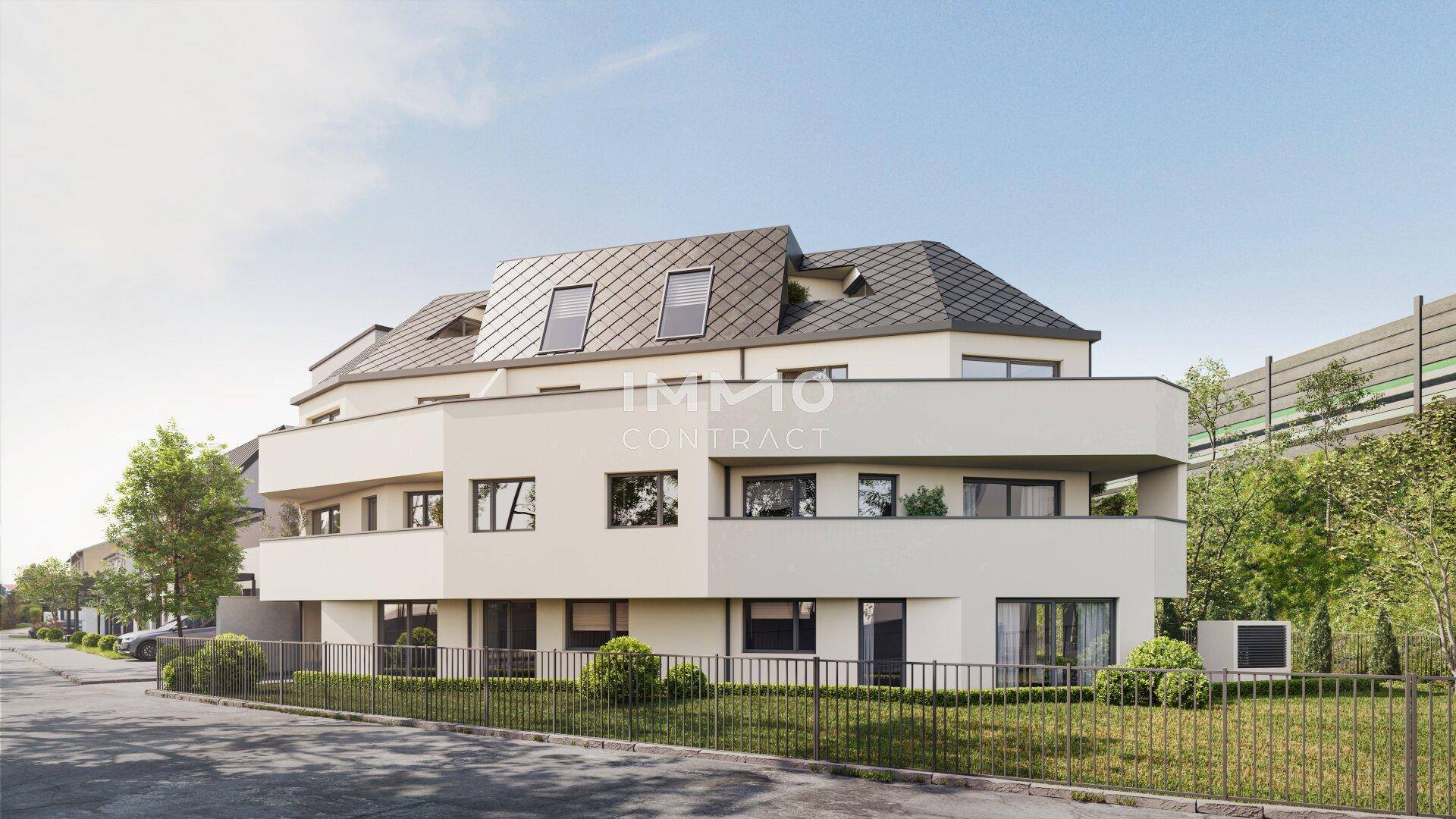 Zeitgenössisches Mehrfamilienhaus mit klarer Architektur und umliegender Grünfläche.
