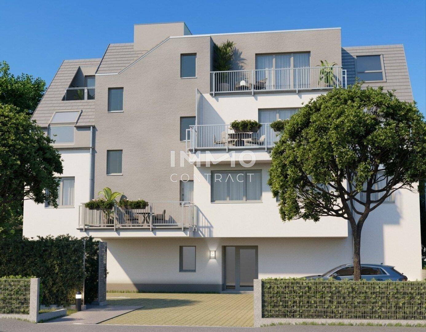 Modernes Mehrfamilienhaus mit mehreren Balkonen und gepflegter Außenanlage.