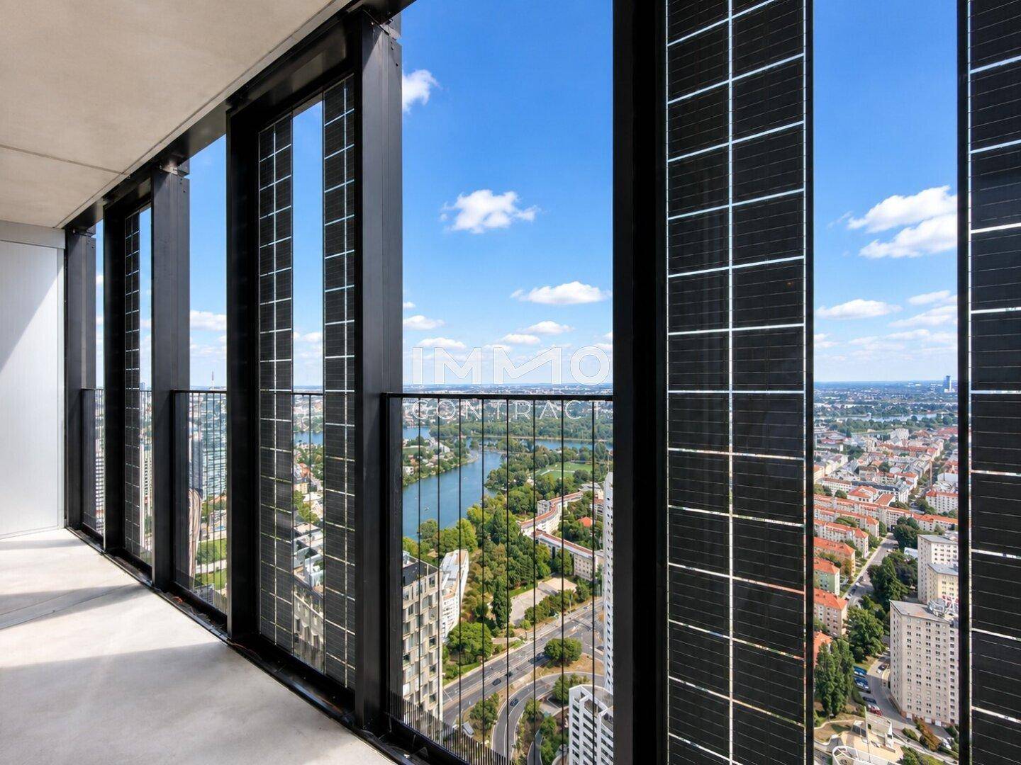Balkon mit atemberaubendem Blick auf die Stadt und den Fluss, umgeben von modernen Gebäuden.