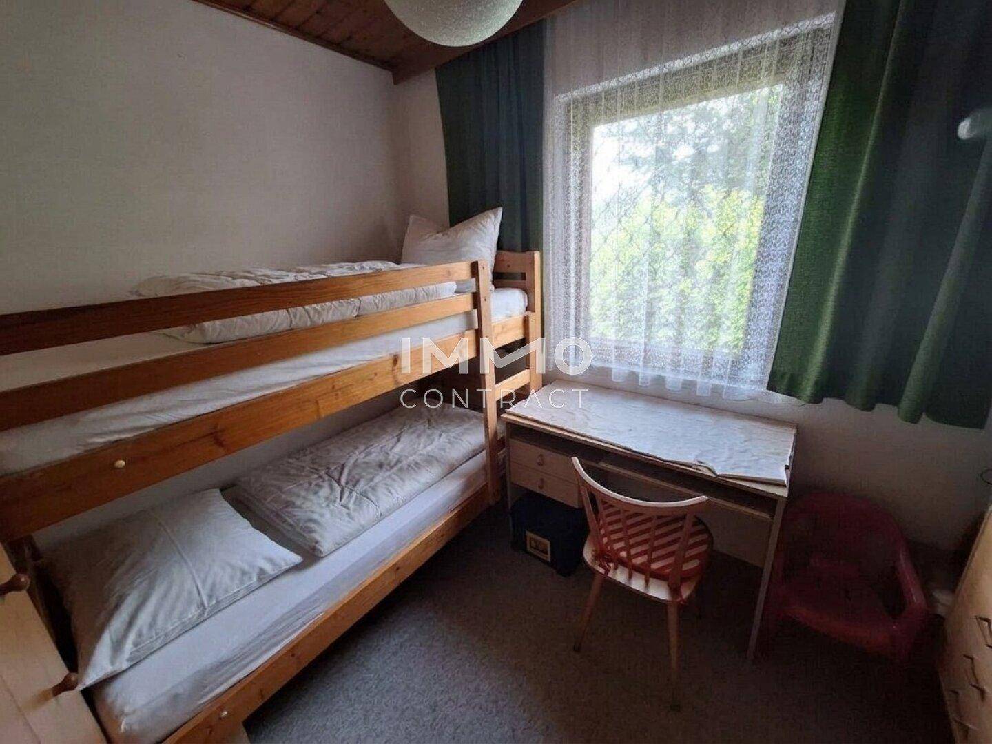 Kinderzimmer mit Etagenbett und Schreibtisch, ideal für Geschwister oder Gäste.