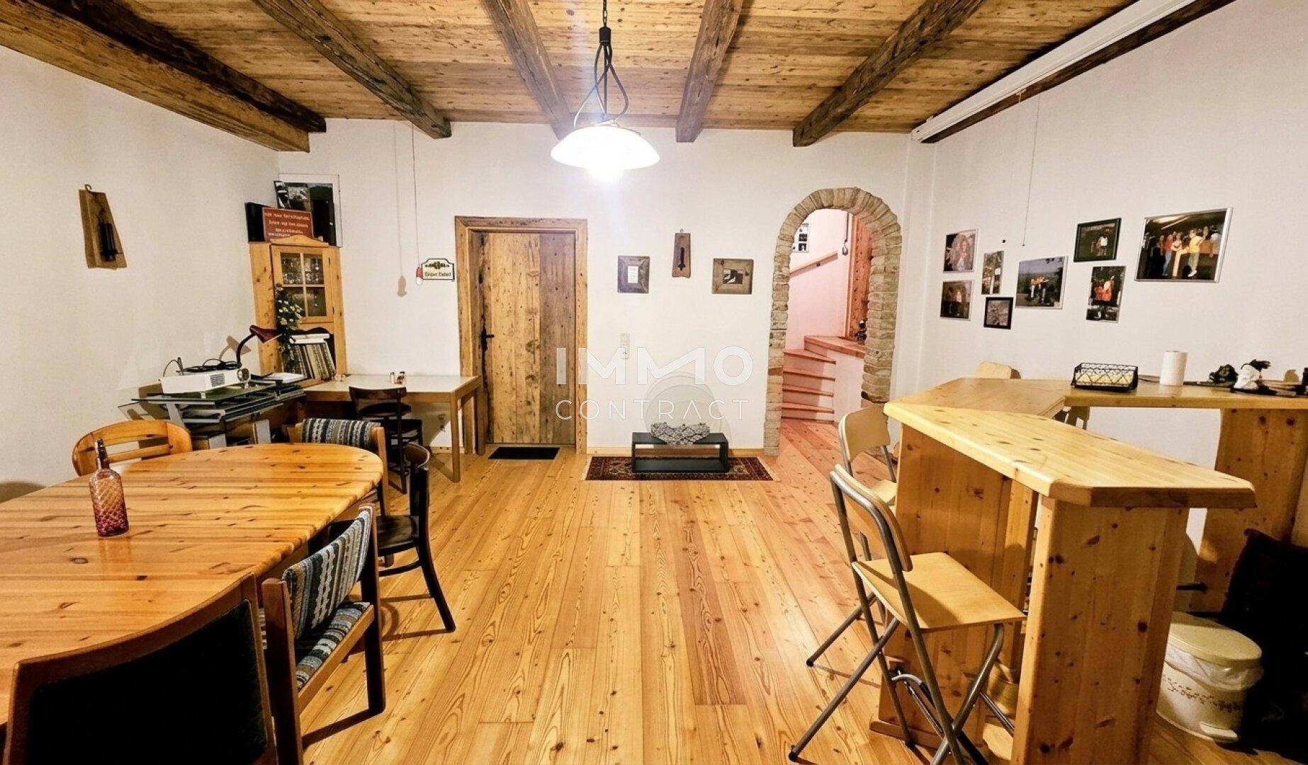 Rustikaler Gemeinschaftsraum mit Holzbalkendecke, Holzboden und Bartresen für gesellige Abende.