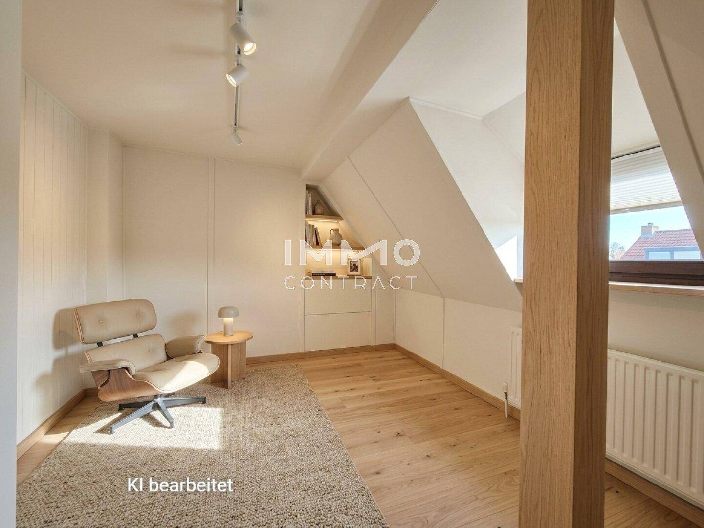 Helles Dachzimmer mit Holzboden, Dachschrägen und gemütlichem Sessel.