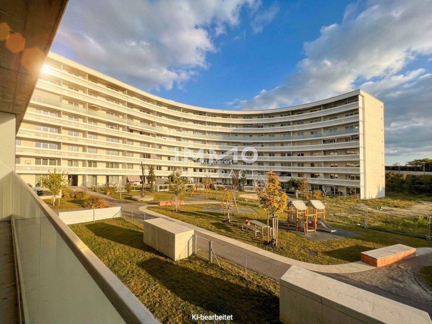 Moderne Wohnanlage mit geschwungener Architektur, großem Innenhof und Kinderspielplatz.