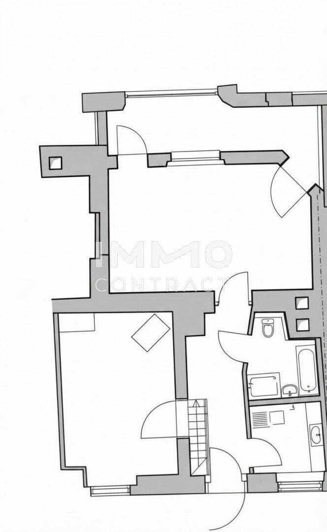 Grundriss einer Wohnung mit Bad, separatem Gäste-WC, Küche und interner Treppe.