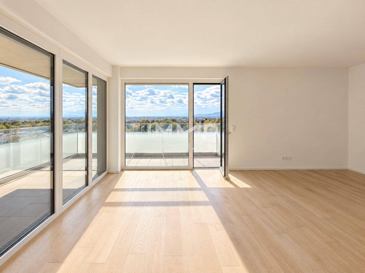Geräumiges Wohnzimmer mit viel Tageslicht durch große Fenster und Balkonzugang.