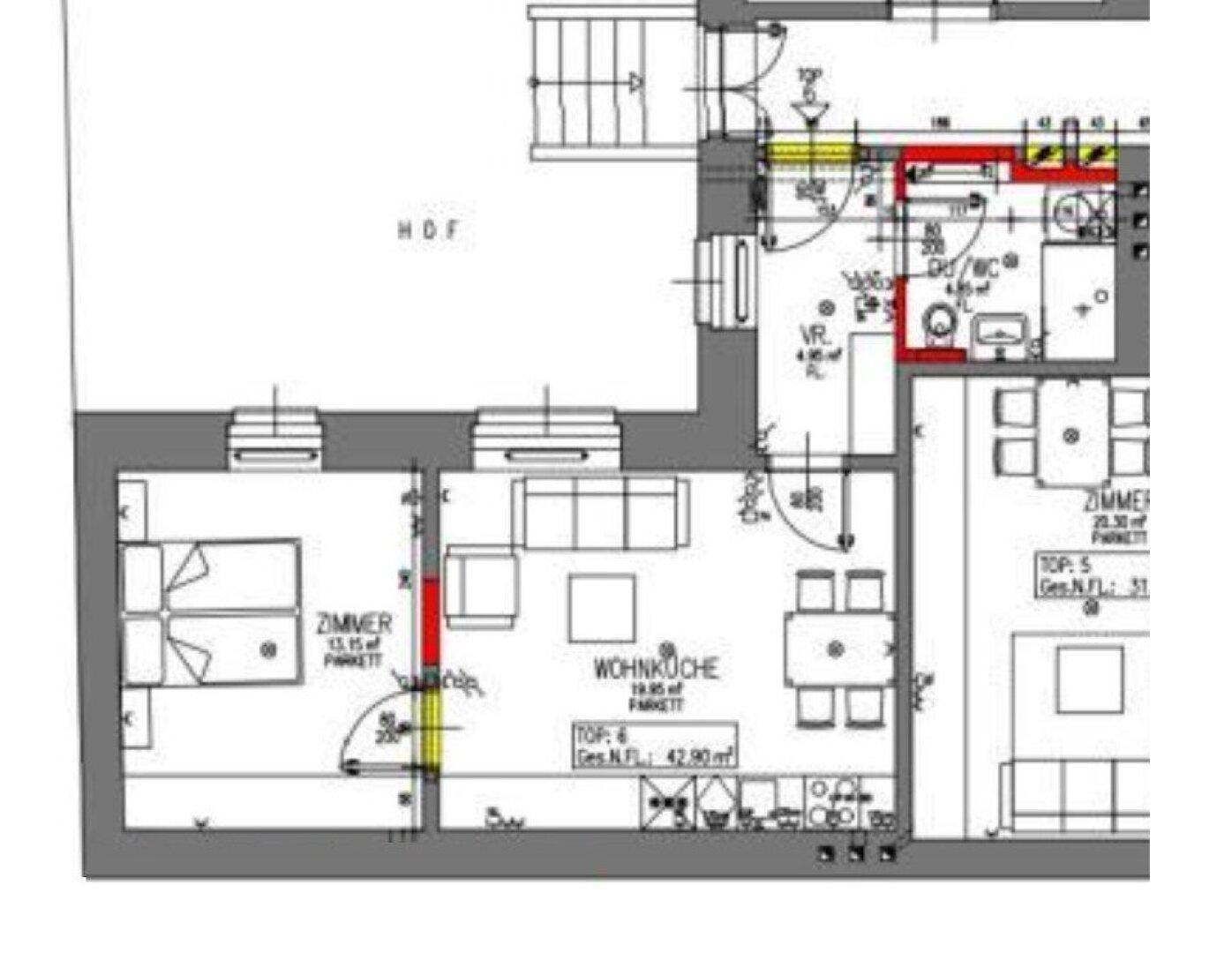 Grundriss einer Wohnung mit offener Wohnküche, zwei Zimmern und Badezimmer.