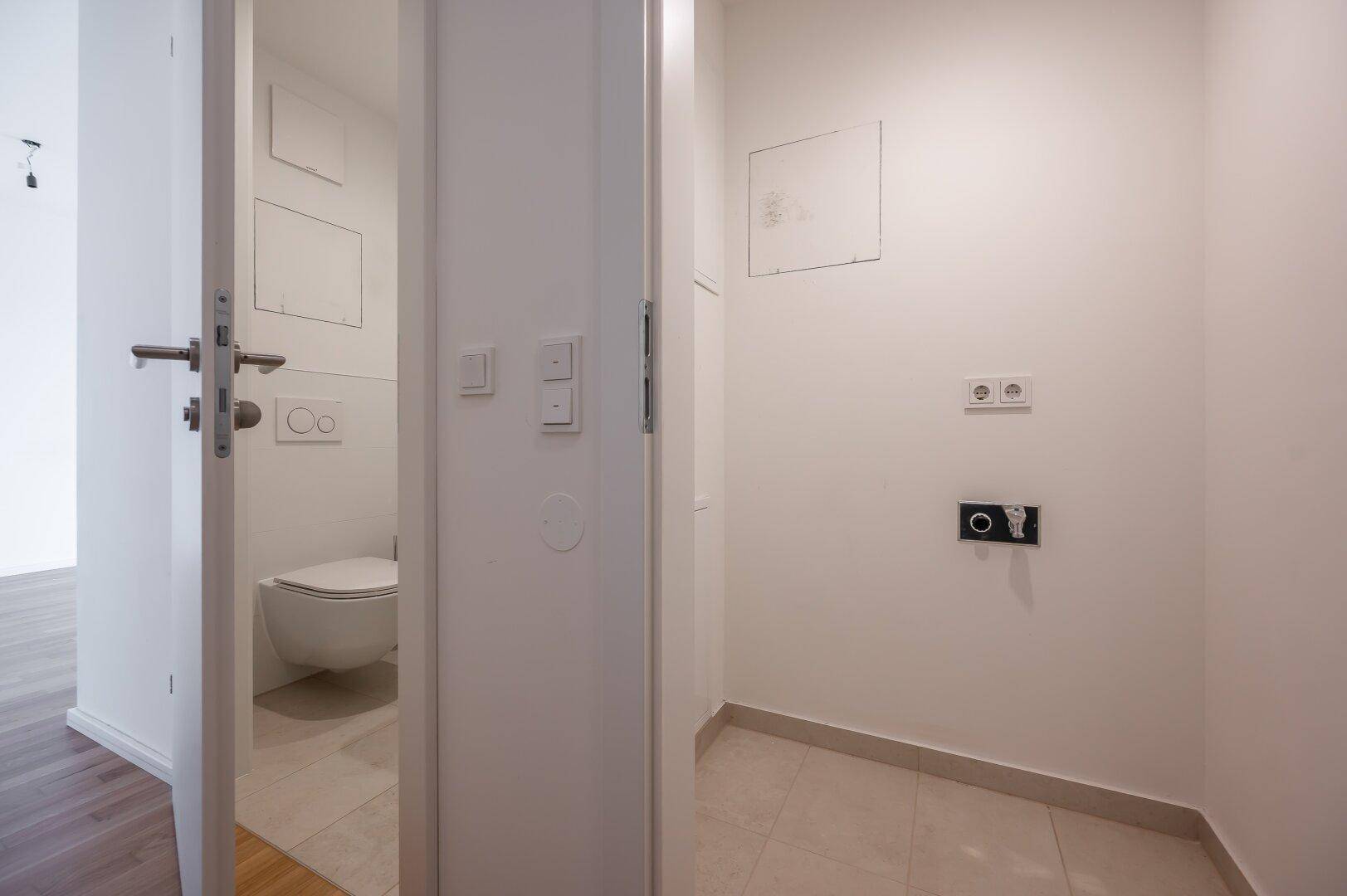 Separates WC mit Wand-WC und Vorbereitung für Waschmaschinenanschluss.