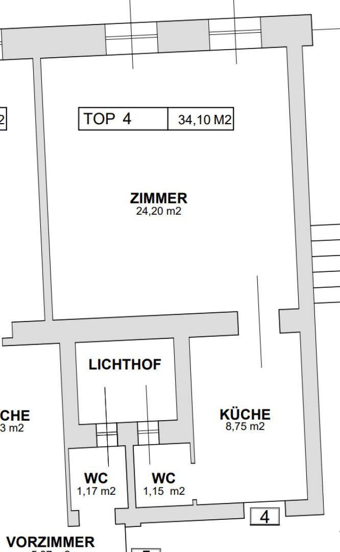 Grundriss einer Wohnung mit Zimmer, Küche, Lichthof und zwei WCs.