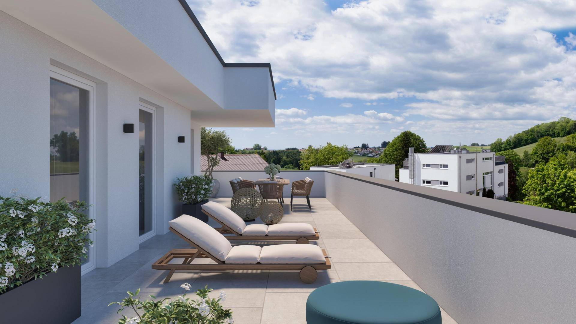 Geräumige Dachterrasse mit modernen Lounge-Möbeln und weitem Blick über die grüne Landschaft.