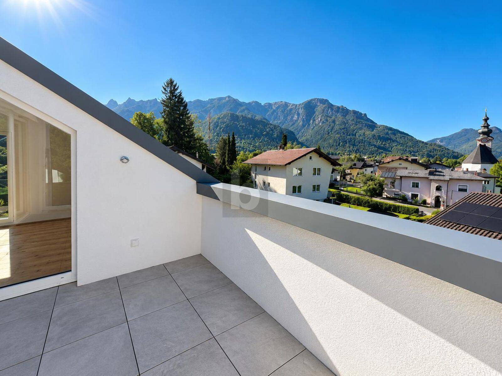 Geräumige Terrasse mit Fliesenboden und Panoramablick auf die Berge und die umliegende Landschaft.