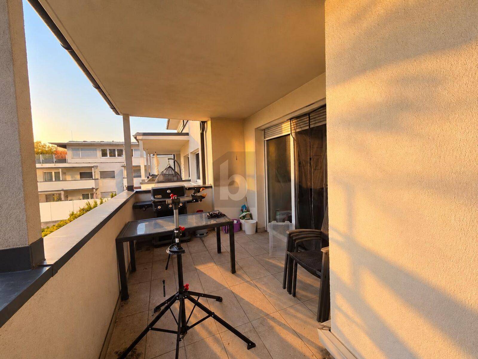 Geräumiger Balkon mit Grillbereich und Sitzgelegenheiten, ideal für entspannte Abende im Freien.