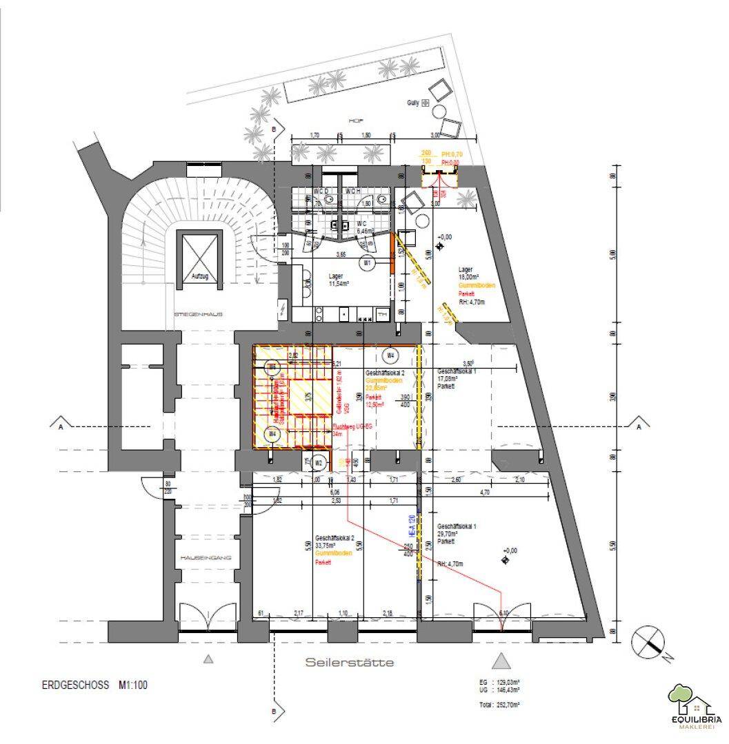 Grundriss des Erdgeschosses mit mehreren Geschäftsflächen, einem Treppenhaus und einem kleinen Außenbereich.