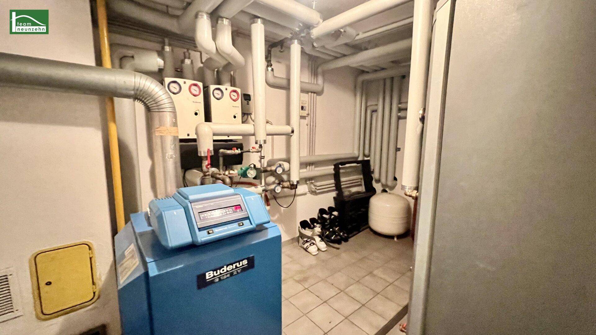 Heizungsraum im Keller mit Buderus-Heizkessel und umfangreicher Rohrinstallation.