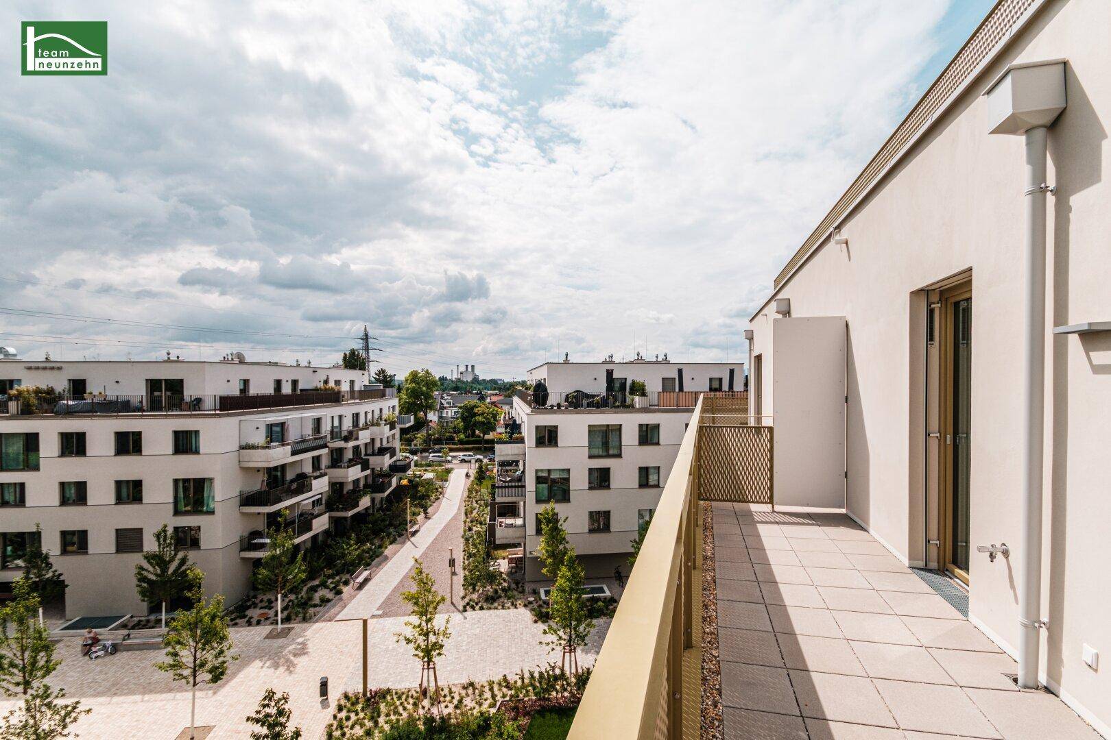 Geräumiger Balkon mit Weitblick über die Wohnanlage und die umliegende Stadtlandschaft.