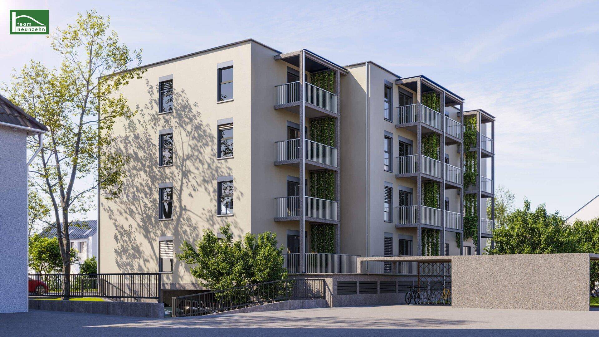 Wohngebäude mit mehreren Balkonen, moderner Architektur und Zufahrt zur Tiefgarage.