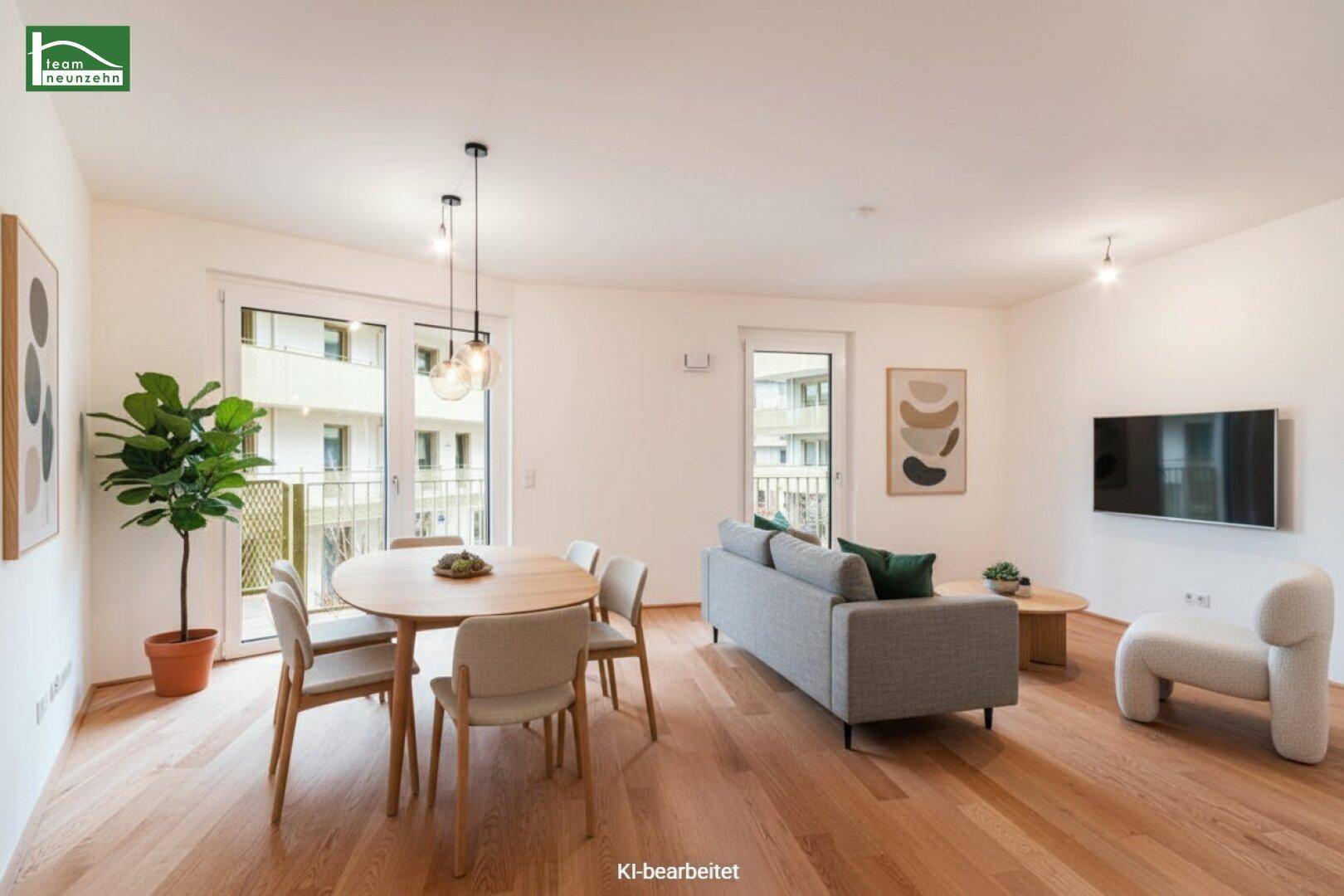 Modern eingerichteter Wohn-Essbereich mit Holzboden und Zugang zum Balkon.