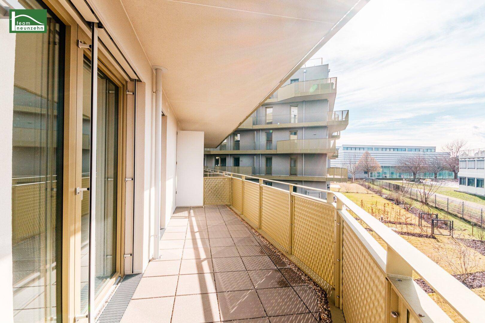 Sonniger Balkon mit Zugang durch große Glastüren, bietet viel Platz und eine angenehme Aussicht.
