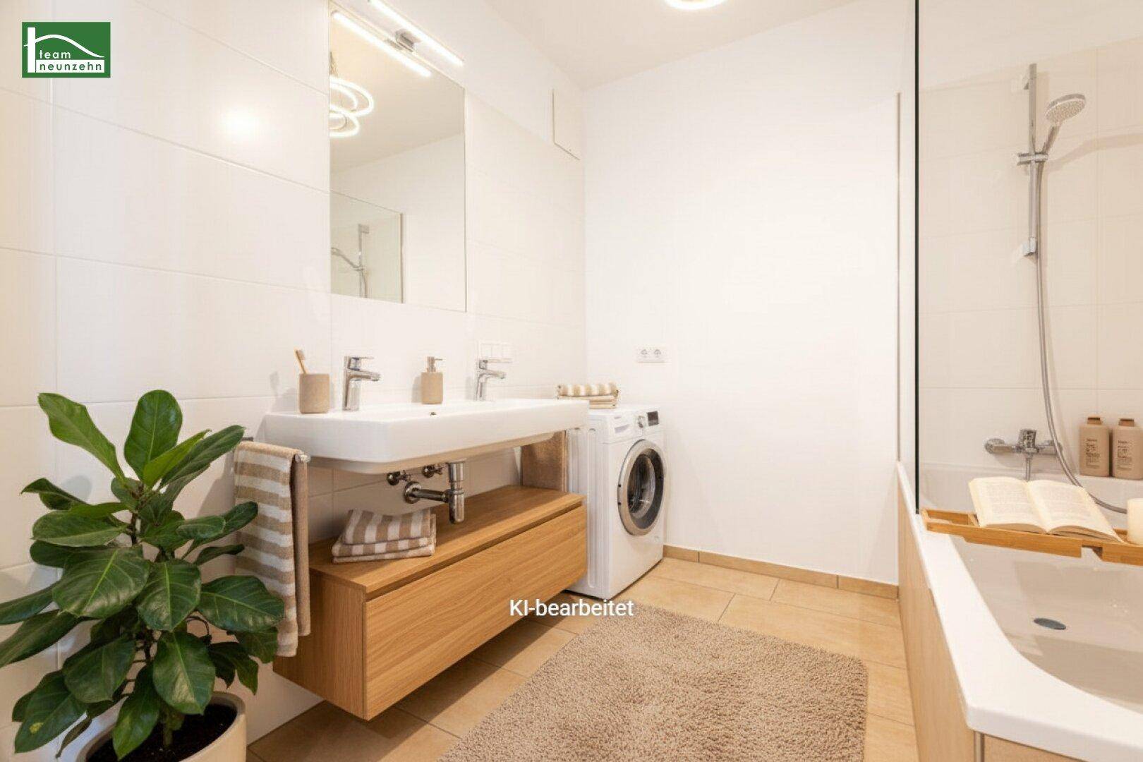 Modernes Badezimmer mit Doppelwaschbecken, Badewanne und Waschmaschine.