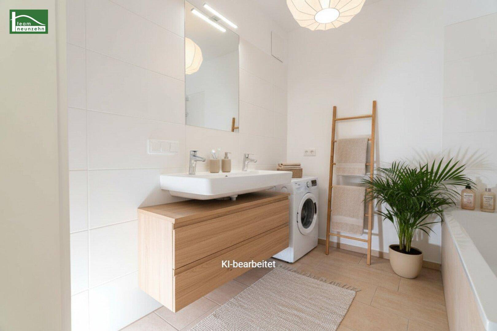Modernes Badezimmer mit Doppelwaschbecken, Waschmaschine und Badewanne, hell gefliest.