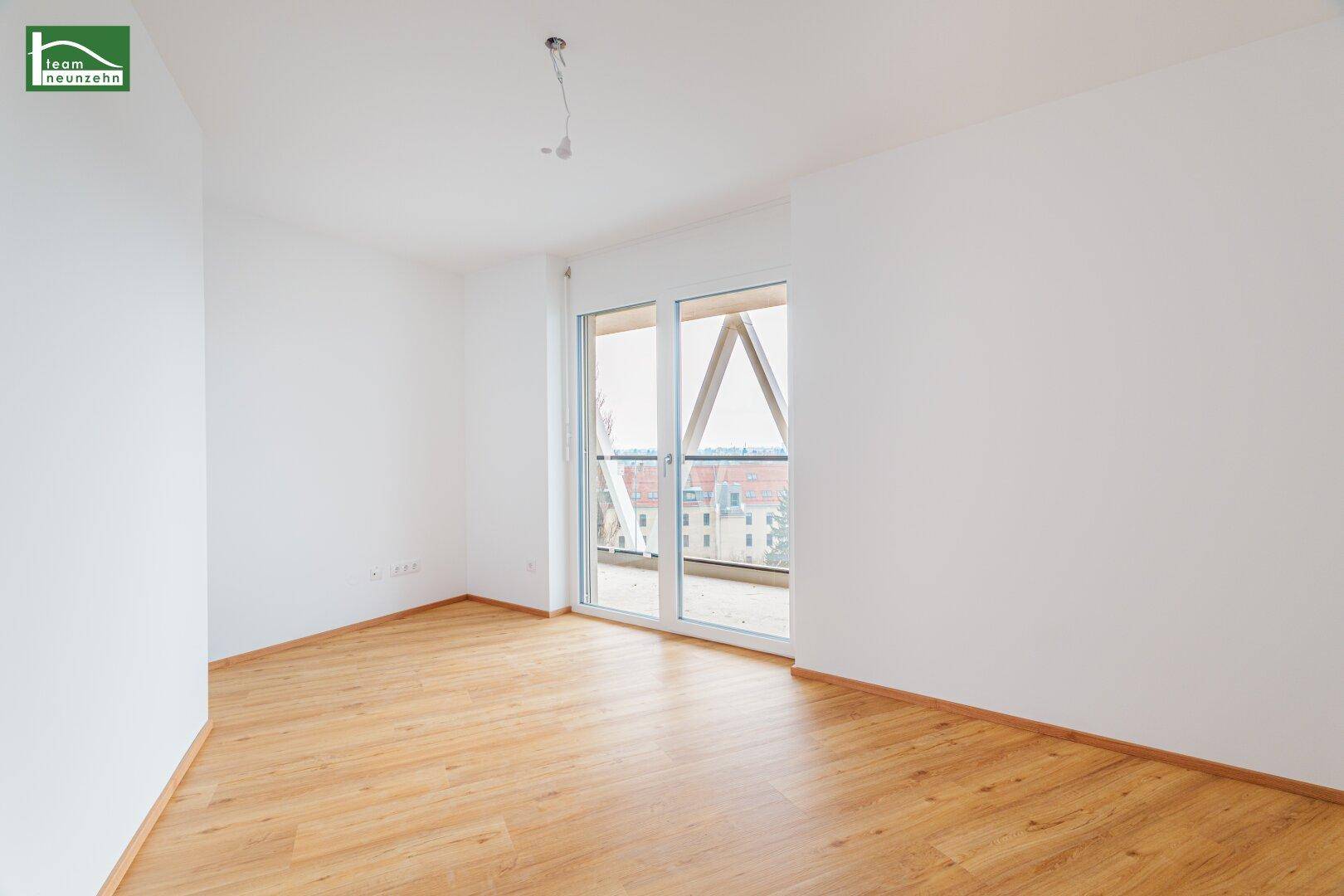 Helles Zimmer mit Laminatboden und Balkonzugang, ideal als Kinder- oder Gästezimmer.