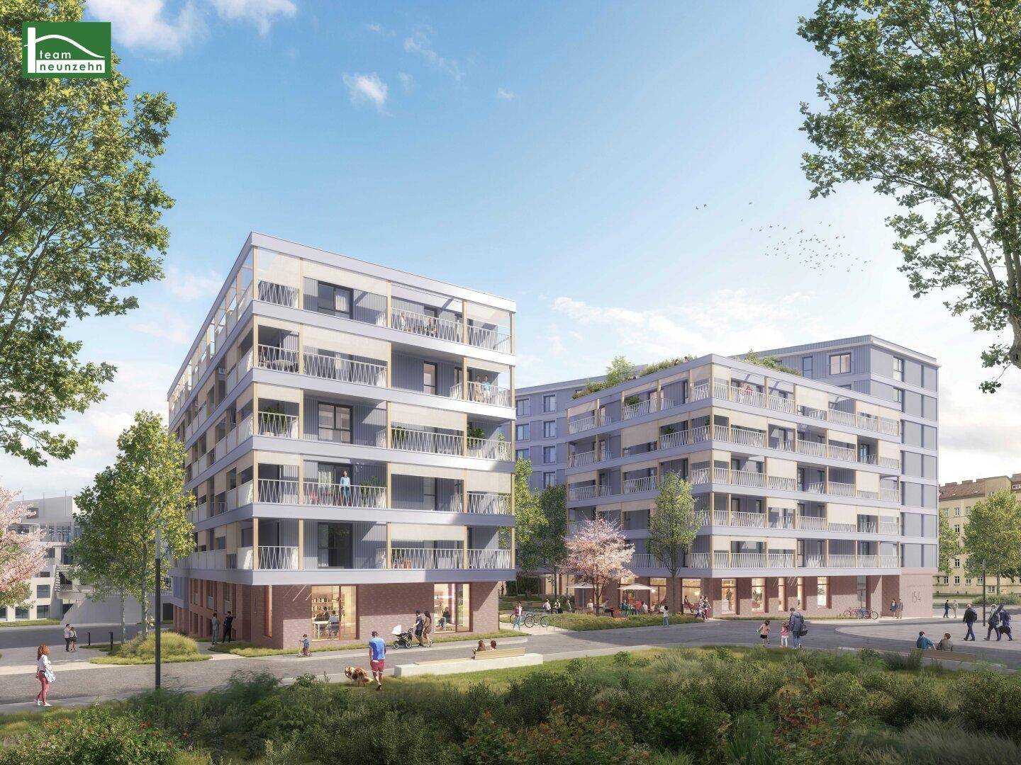 Neue Wohngebäude mit Balkonen und begrünten Außenanlagen in städtischer Umgebung.