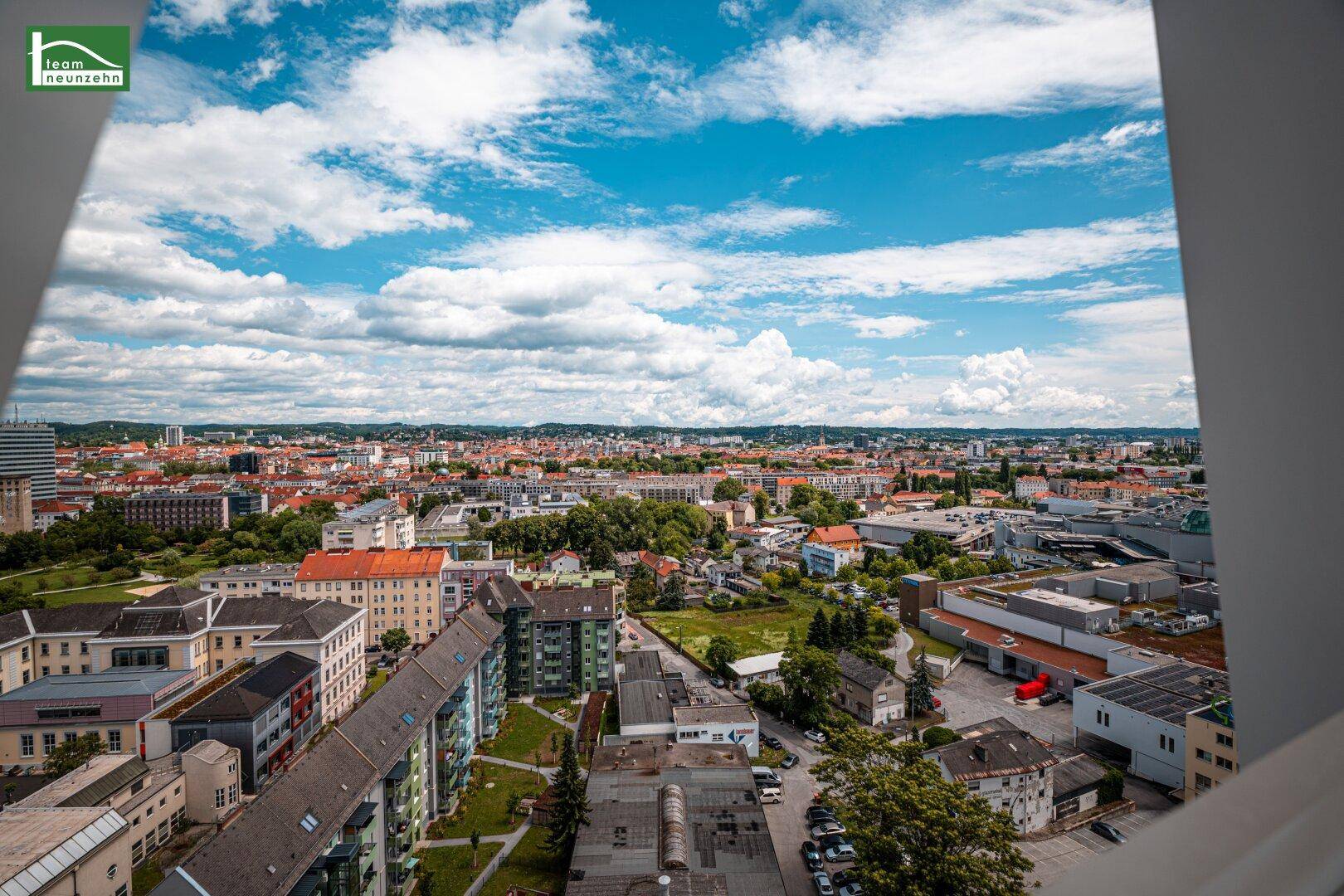 Panoramablick über die Stadt mit zahlreichen Gebäuden und einer weiten Himmelslandschaft.