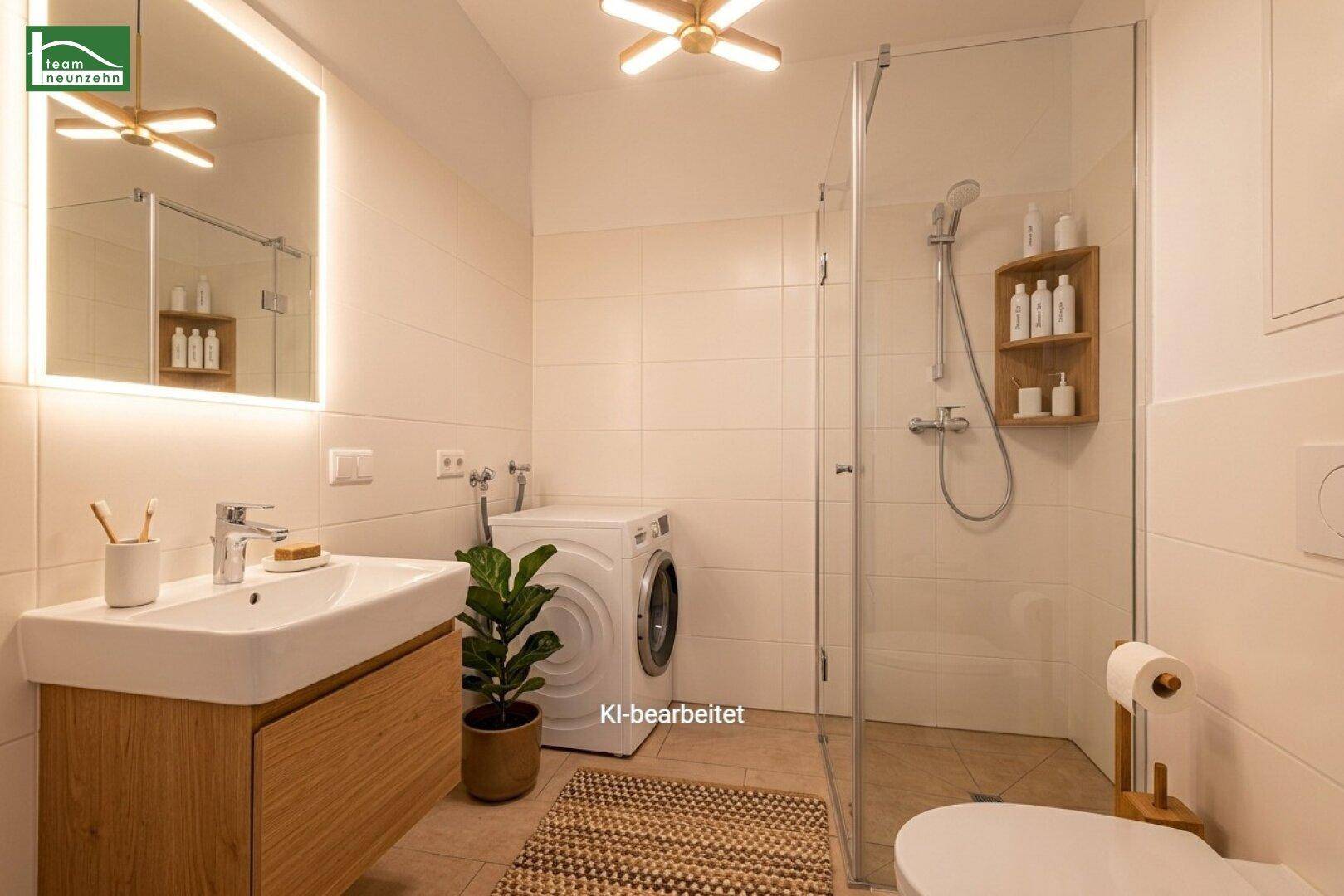 Modernes Badezimmer mit ebenerdiger Dusche, beleuchtetem Spiegel und integrierter Waschmaschine.