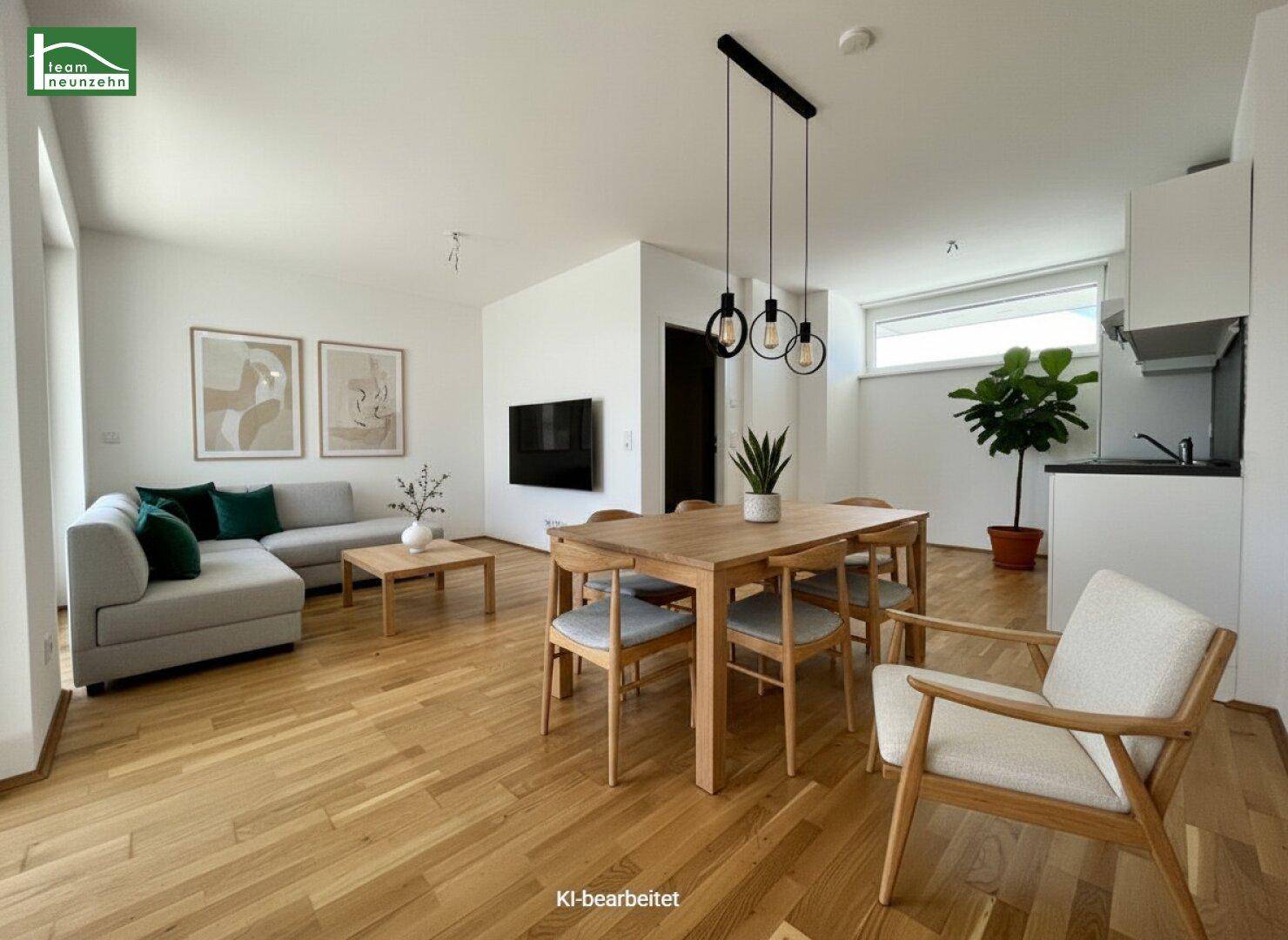 Stilvoll eingerichteter Wohn-Essbereich mit Holztisch, Sofa und integrierter Küchenzeile.