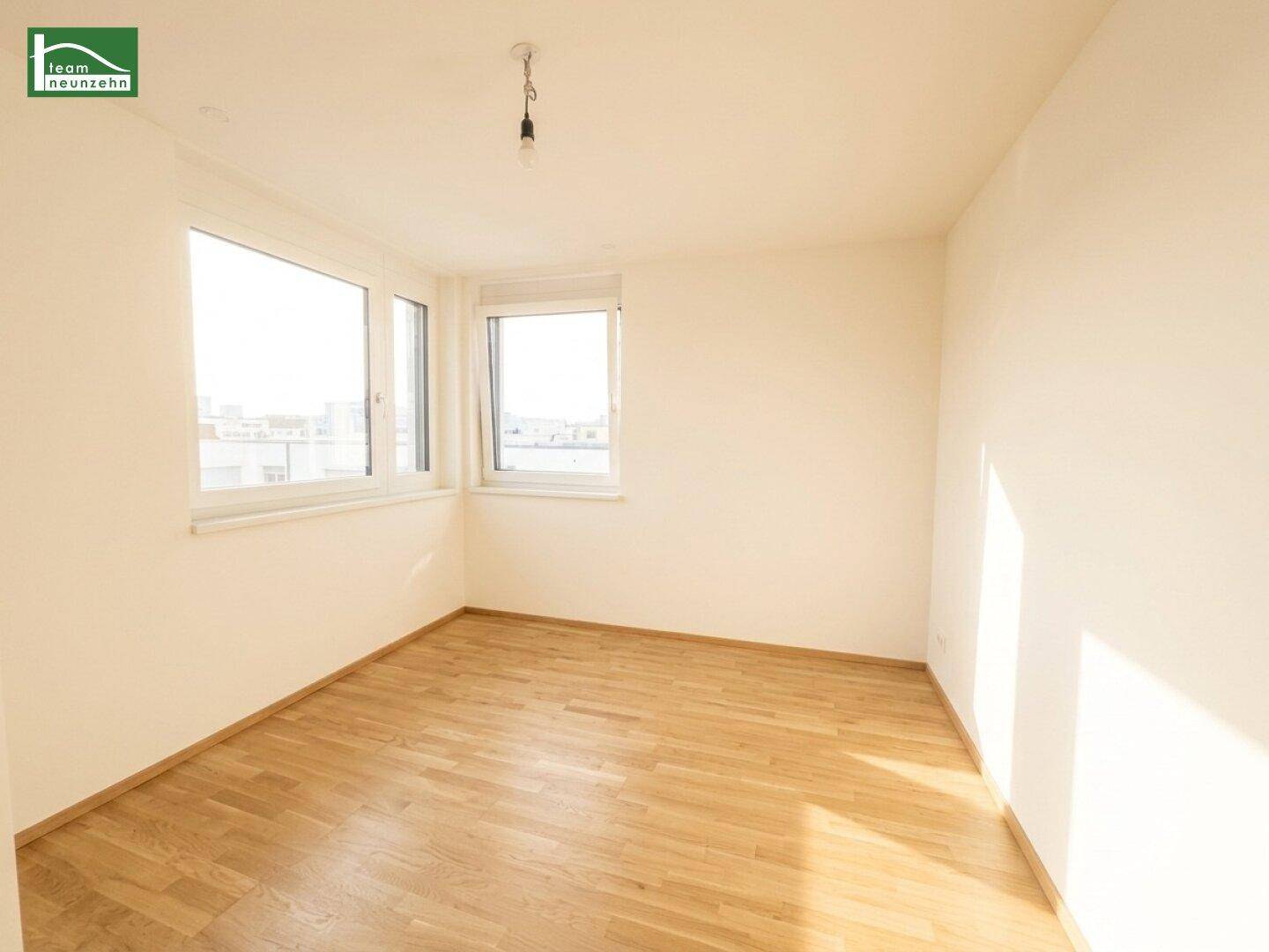 Helles Schlafzimmer mit Holzboden und großen Fenstern, die viel Tageslicht hereinlassen und eine weite Aussicht bieten.