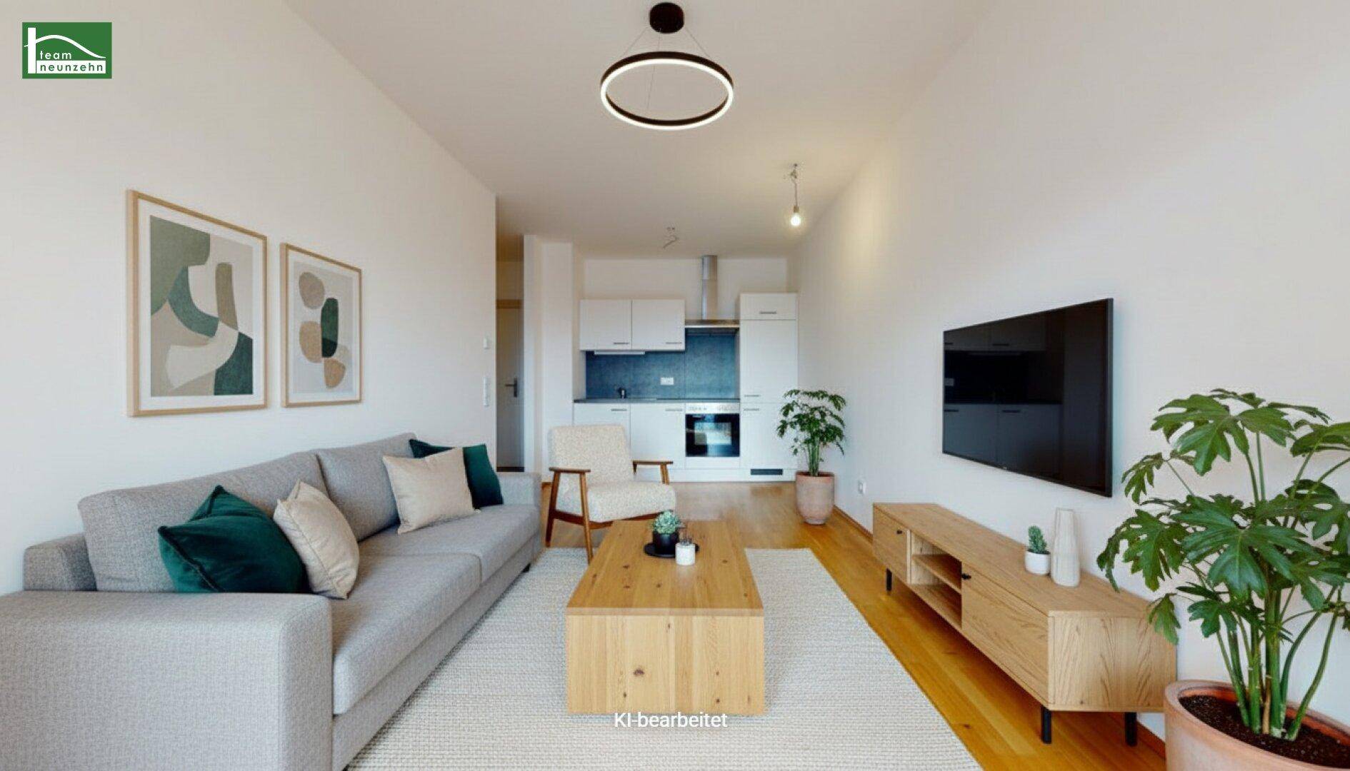 Modern eingerichtetes Wohnzimmer mit offener Küche, Holzboden und stilvollen Dekorationselementen.