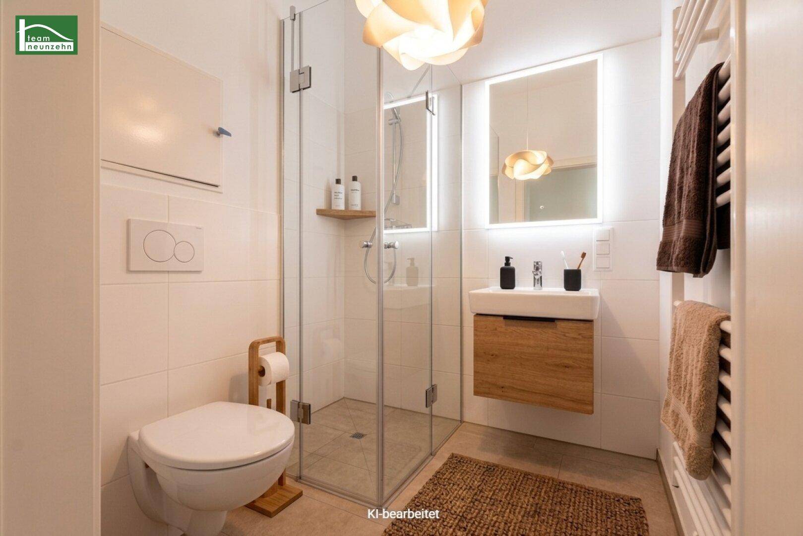 Modernes Badezimmer mit ebenerdiger Dusche, schwebendem Waschtisch und beheiztem Handtuchhalter.