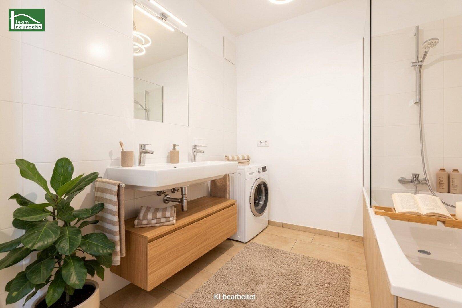 Modernes Badezimmer mit Doppelwaschbecken, Badewanne und Waschmaschine.