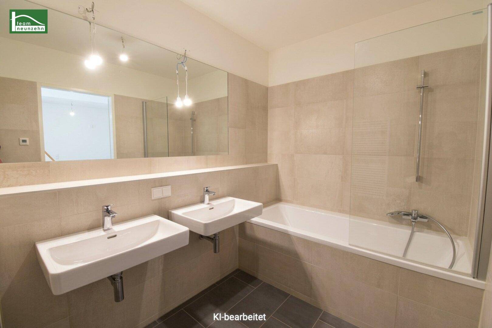 Modernes Badezimmer mit Doppelwaschbecken, Badewanne und großen Spiegeln, in hellen Beigetönen gefliest.