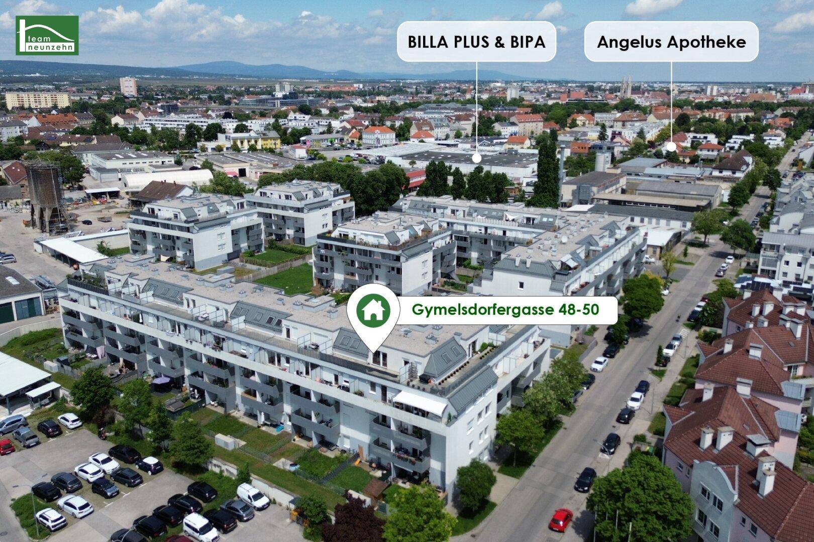 Luftaufnahme des modernen Wohnkomplexes mit umliegender Bebauung und Infrastruktur.